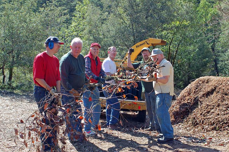 Group At Chipper.jpg - (L-R): Gabriel Faber, Lawrence Summers, Bill Palmer, Steven Graham, Ken Henry and Bruce Raby are ready to load a large branch into the chipper.
